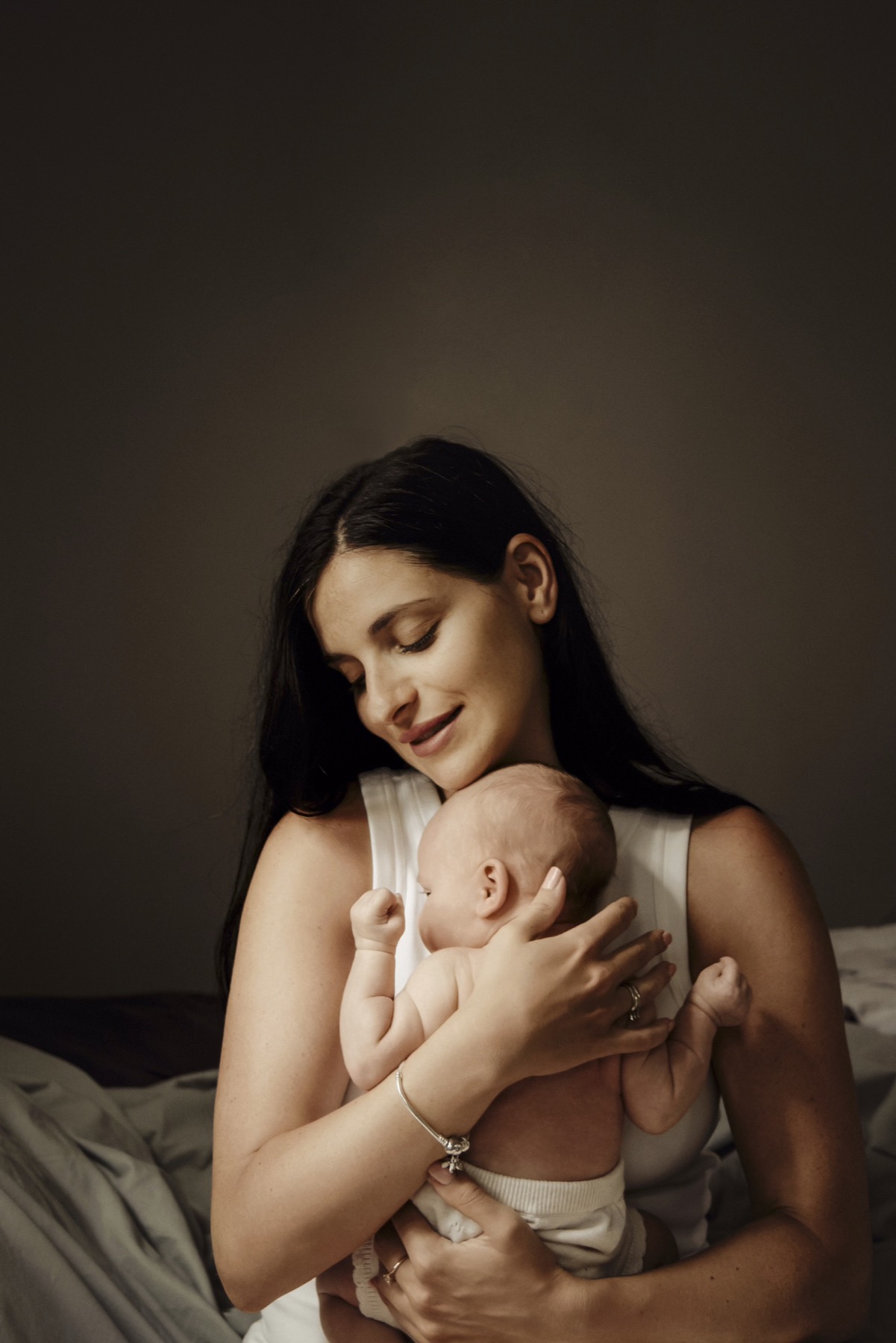 Mother holding her baby close in soft natural light