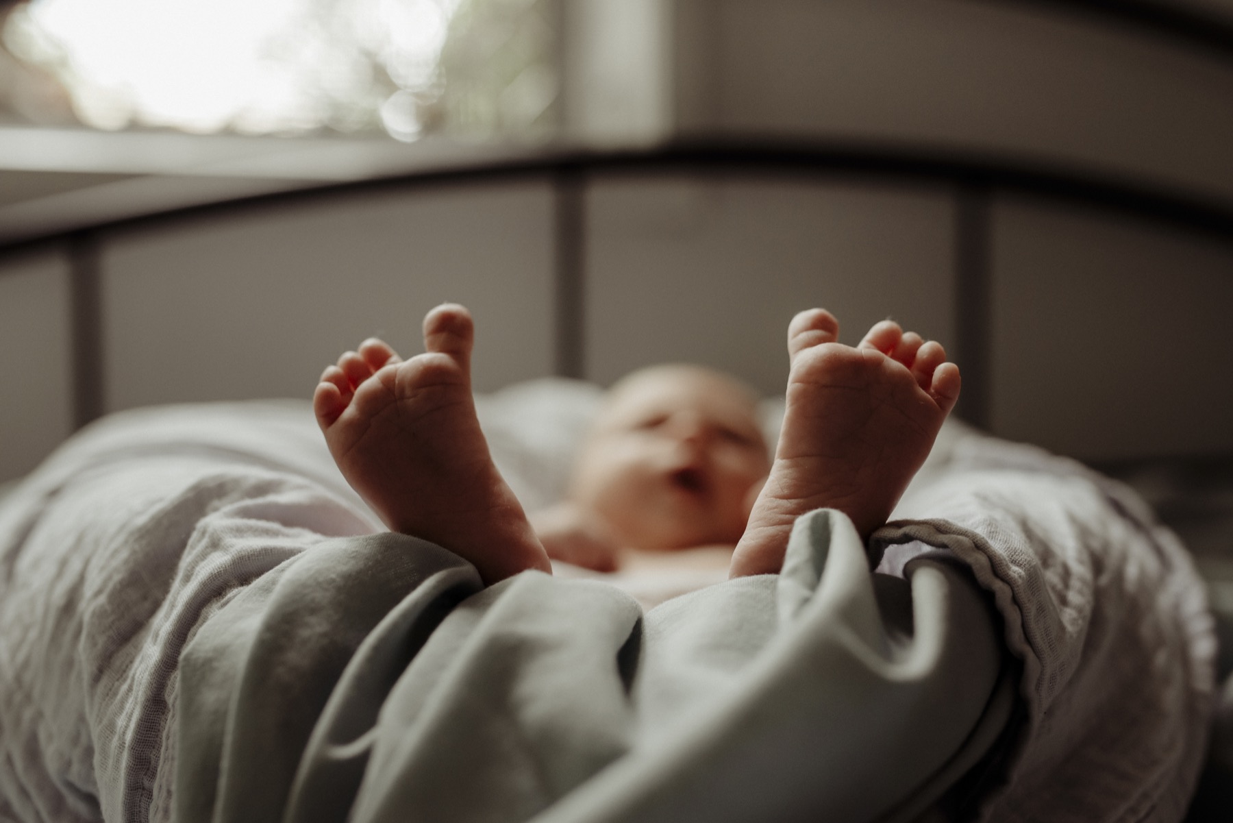 Baby feet peeking out from soft blankets