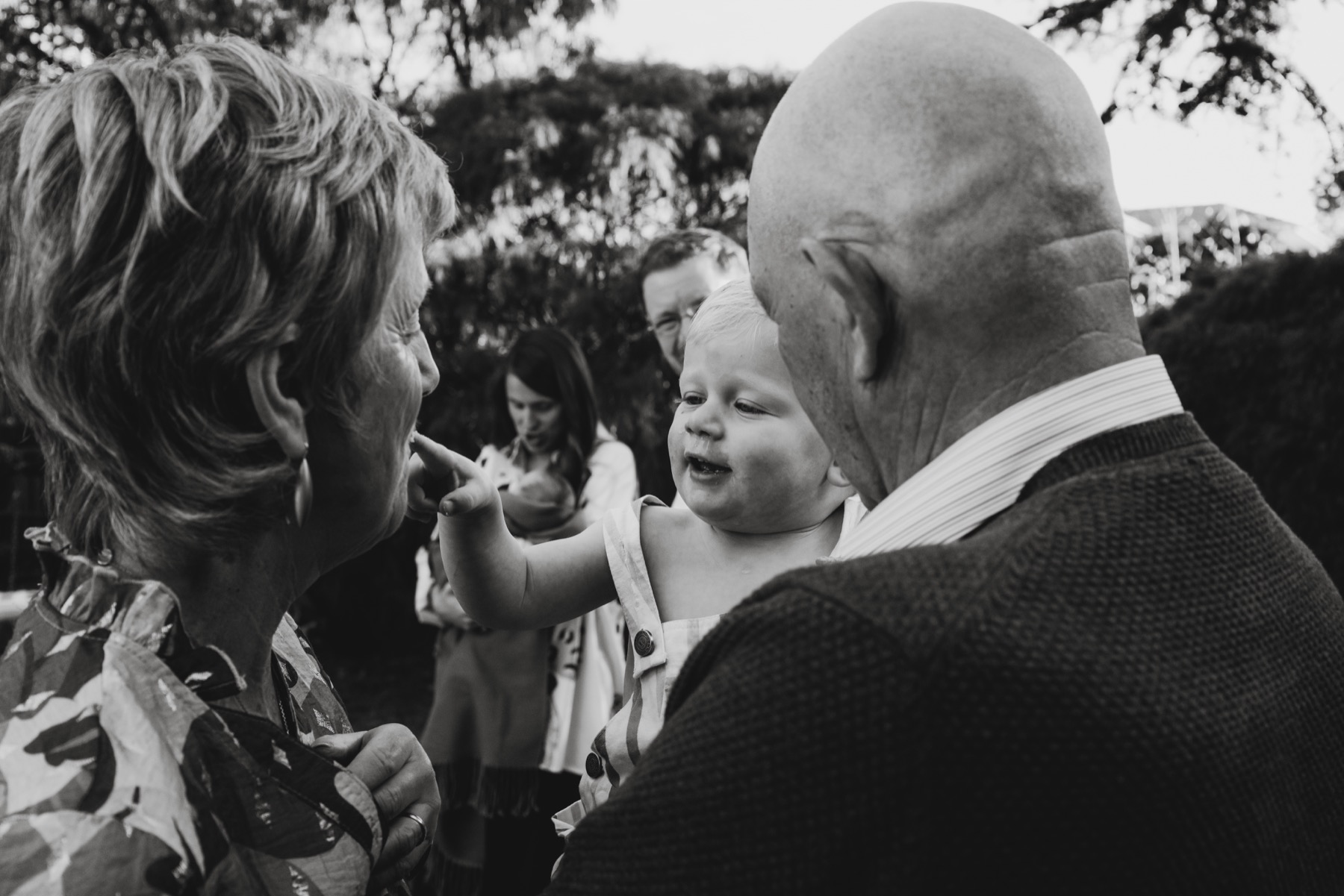 A child sharing a moment with family outdoors